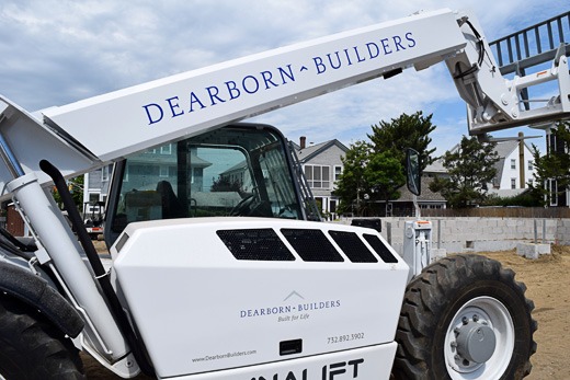 Boom loader with Dearborn Builders logo